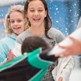 Girl student laughing while ice skating during a school escursion at Cockburn Ice Arena